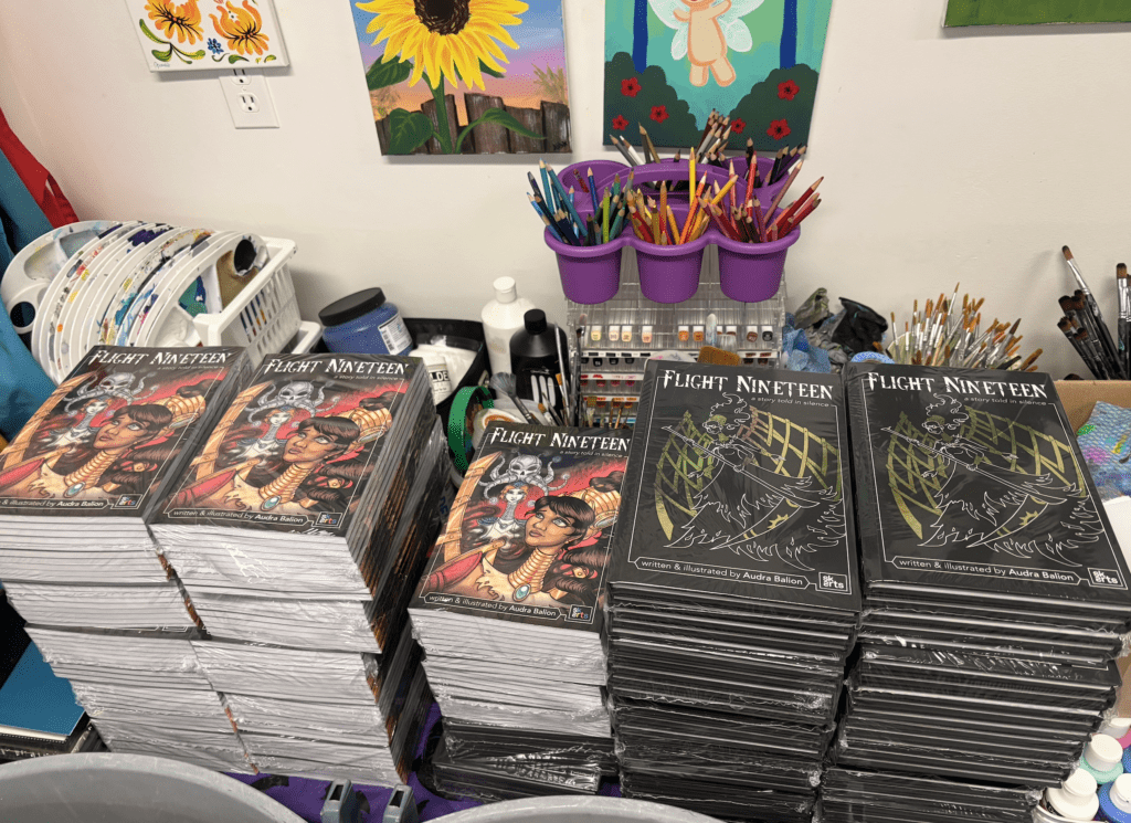 Stacks of books for Flight Nineteen laid out at Audra Balion Art Sanctuary.